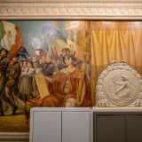 A seguire, il dipinto si concentra sui �giovani Balilla�, con fez e camicie nere, che avanzano con le �piccole Italiane�, mentre tutt�attorno sventolano bandiere tricolori